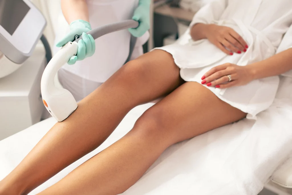 image of a woman receiving legs and body laser hair removal treatment with a machine